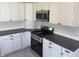 Modern kitchen featuring stainless steel appliances, gray countertops, and bright white cabinets at 1378 Hannibal St, Noblesville, IN 46060