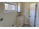 A clean laundry room featuring grey floors and cabinets with granite countertops at 1378 Hannibal St, Noblesville, IN 46060