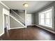 Bright living room with hardwood floors, stairway, and a large window at 1378 Hannibal St, Noblesville, IN 46060
