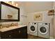 Modern bathroom featuring a sleek vanity, stylish fixtures, and a convenient washer and dryer, offering comfort and functionality at 1404 Broadway St # Apt G, Indianapolis, IN 46202