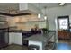 Well-lit kitchen with white cabinetry, stainless steel appliances, and a functional island, perfect for culinary enthusiasts at 1404 Broadway St # Apt G, Indianapolis, IN 46202