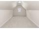 Finished attic space with carpeting and natural light from the window at 1429 Fletcher Ave, Indianapolis, IN 46203