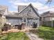 Backyard features a deck with patio seating, detached garage and partially fenced yard at 1429 Fletcher Ave, Indianapolis, IN 46203