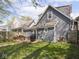 Backyard features a deck with patio seating, detached garage and partially fenced yard at 1429 Fletcher Ave, Indianapolis, IN 46203