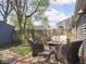 Backyard deck features patio seating with an outdoor sofa and chairs around a fire pit in a fenced yard at 1429 Fletcher Ave, Indianapolis, IN 46203