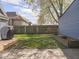 Backyard features a deck, partially fenced yard and detached garage with grill at 1429 Fletcher Ave, Indianapolis, IN 46203