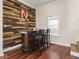 Cozy bar area features hardwood floors, a rustic wood bar, and accent wall at 1429 Fletcher Ave, Indianapolis, IN 46203
