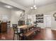 Open-concept dining room boasts hardwood floors, staircase, and a rustic wood table with seating at 1429 Fletcher Ave, Indianapolis, IN 46203