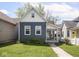Inviting home with a blue exterior, well-kept lawn, and a paved walkway leading to the entrance at 1429 Fletcher Ave, Indianapolis, IN 46203