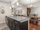 Open-concept kitchen with granite island, stainless steel appliances, and view into the living area at 1429 Fletcher Ave, Indianapolis, IN 46203