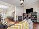 Bright living room featuring a modern fireplace with tile surround and built-in shelving for storage and decor at 1429 Fletcher Ave, Indianapolis, IN 46203