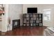 Modern living area with a fireplace, entertainment center, and hardwood floors, offering a stylish and functional space at 1429 Fletcher Ave, Indianapolis, IN 46203