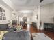 Open concept living space with hardwood floors, fireplace, and seamless flow to the dining area, perfect for entertaining at 1429 Fletcher Ave, Indianapolis, IN 46203