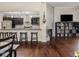 Open concept living space that combines the living room and kitchen with breakfast bar and lots of light at 1429 Fletcher Ave, Indianapolis, IN 46203