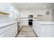 Modern kitchen featuring white cabinets, stainless steel appliances, durable countertops, and hardwood floors at 14544 Hanford Ln, Carmel, IN 46074