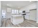 Modern eat-in kitchen featuring white cabinets, stainless steel appliances, and durable countertops at 14544 Hanford Ln, Carmel, IN 46074