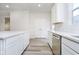 Modern kitchen featuring white cabinets, stainless steel appliances, durable countertops, and hardwood floors at 14544 Hanford Ln, Carmel, IN 46074