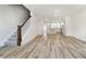 Open-concept living room with modern kitchen, hardwood floors, recessed lighting, and a staircase at 14544 Hanford Ln, Carmel, IN 46074