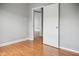 The cozy bedroom features light gray walls, trim, and wood flooring at 1509 Sycamore St, Columbus, IN 47201