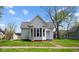 Exterior view of home with red brick foundation, light siding, and inviting curb appeal at 1509 Sycamore St, Columbus, IN 47201