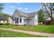 Charming home featuring light siding, a red brick foundation, and well-maintained landscaping at 1509 Sycamore St, Columbus, IN 47201