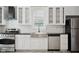 Updated kitchen with a farmhouse sink, stainless steel appliances, and subway tile at 1509 Sycamore St, Columbus, IN 47201
