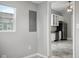 The kitchen is visible from an adjacent room, featuring white cabinets, stainless steel appliances, and gray walls at 1509 Sycamore St, Columbus, IN 47201
