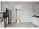 Spacious kitchen with stainless appliances, granite countertops, and gray flooring at 1509 Sycamore St, Columbus, IN 47201