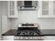 A stainless steel gas range and range hood in an updated kitchen at 1509 Sycamore St, Columbus, IN 47201