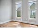 Well lit living room features light gray walls with wood paneled wall and hardwood floors at 1509 Sycamore St, Columbus, IN 47201