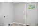 Neutral mud room featuring gray walls, white trim, and a door with a window panel at 1509 Sycamore St, Columbus, IN 47201