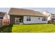 Back exterior showcases the patio, well-manicured lawn, and attractive architectural details at 15655 Woodford Dr, Westfield, IN 46074