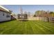 Large backyard features a trampoline, well-maintained lawn, and a view of neighboring homes at 15655 Woodford Dr, Westfield, IN 46074