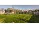 Spacious backyard features a trampoline, lush green lawn, and a privacy fence at 15655 Woodford Dr, Westfield, IN 46074