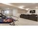 Finished basement with a sports net, gym equipment, and sectional sofa at 15655 Woodford Dr, Westfield, IN 46074