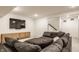 Finished basement with a TV, wicker console, and comfy gray sectional at 15655 Woodford Dr, Westfield, IN 46074