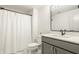 Bright bathroom features a modern vanity, large mirror, and a shower with a white curtain at 15655 Woodford Dr, Westfield, IN 46074