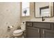 Stylish powder room with floral wallpaper, gray vanity, and a decorative mirror reflecting the adjacent space at 15655 Woodford Dr, Westfield, IN 46074