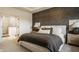 Bedroom features a decorative accent wall, neutral furnishings, and an ensuite bathroom at 15655 Woodford Dr, Westfield, IN 46074