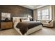 Spacious bedroom features a textured accent wall, a cozy sitting area, and plush carpeting at 15655 Woodford Dr, Westfield, IN 46074