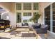 Inviting covered patio with comfortable seating, a grill, and ample natural light at 15655 Woodford Dr, Westfield, IN 46074