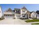 Charming two-story home featuring a three car garage and manicured lawn at 15655 Woodford Dr, Westfield, IN 46074