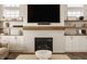 Cozy fireplace with a white brick surround, wooden mantel, and built-in shelves at 15655 Woodford Dr, Westfield, IN 46074