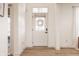 Bright foyer with wood floors, a white front door with a wreath, and views into other rooms at 15655 Woodford Dr, Westfield, IN 46074