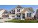 Charming two-story home with a manicured lawn, two-car garage, and beautiful architectural details at 15655 Woodford Dr, Westfield, IN 46074