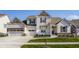 Charming two-story home with a manicured lawn, two-car garage, and beautiful architectural details at 15655 Woodford Dr, Westfield, IN 46074