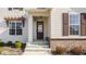 Inviting front porch featuring brick accents, white columns, and a decorative wreath on the front door at 15655 Woodford Dr, Westfield, IN 46074