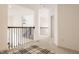 Open hallway with carpet flooring, decorative railing, and natural light creating a welcoming atmosphere at 15655 Woodford Dr, Westfield, IN 46074