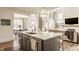Modern kitchen features a spacious island with pendant lighting and an open layout to the living area at 15655 Woodford Dr, Westfield, IN 46074