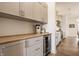 Additional kitchen area with undercounter refrigerator, countertop, and modern light gray cabinetry at 15655 Woodford Dr, Westfield, IN 46074